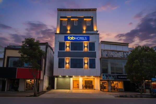 A modern building with a 'fab hotels' sign, featuring a multi-story structure with illuminated windows and a flat roof. - Fabhotel Devara Grand (Hyderabad)