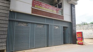 A hotel with a signboard advertising fully AC rooms, couple rooms, corporate rooms, and a restaurant. - Fabhotel Coco Tree (Gurugram)