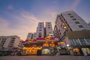 A hotel with multiple floors, a prominent entrance with signage, and a staircase leading to the entrance. - Fabhotel Rajtilak (Ahmedabad)