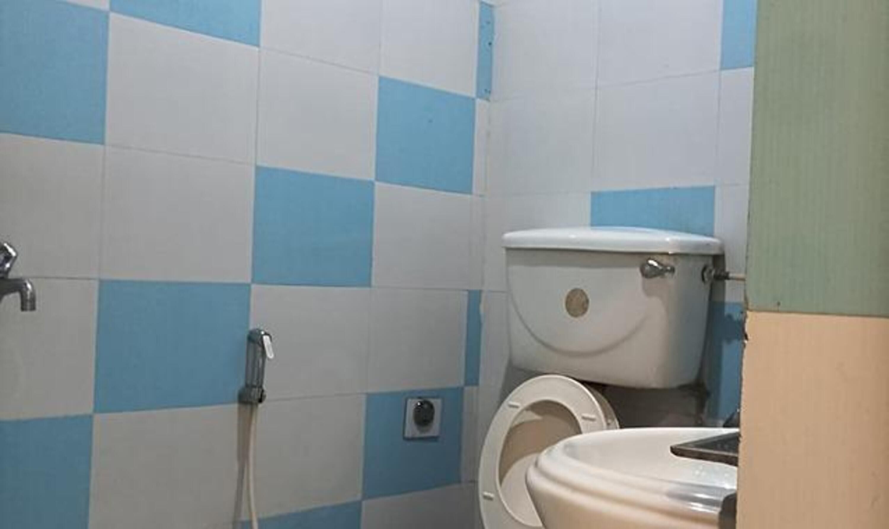 A bathroom with a toilet, a sink, and a shower.