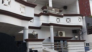 A building with a sign reading "Crown Inn" and a staircase leading to an upper level. - Fabhotel Crown Inn (Lucknow)