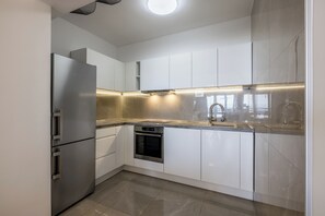 Deluxe Apartment | Private kitchen | Espresso maker, electric kettle, toaster, dining tables