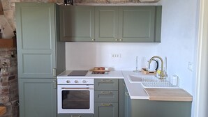 A kitchen with green cabinets, a white countertop, a built-in oven, and a sink. - Hill Pool House, Kaštel Kambelovac Retreat (Kaštel Kambelovac)