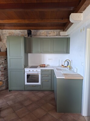 A kitchen with green cabinets, a white countertop, a built-in oven, and a sink. - Hill Pool House, Kaštel Kambelovac Retreat (Kaštel Kambelovac)