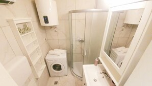 A compact bathroom with a toilet, washing machine, shower, and sink. - Koko&Friends, Charming Place In Quite Neighborhood (Split)