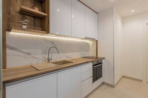 Luxury Apartment | Private kitchen | Electric kettle, highchair, dining tables