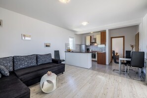 Deluxe Apartment | Living area | 36-inch flat-screen TV with cable channels