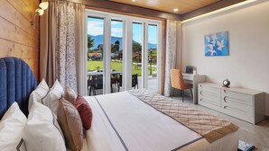 A bedroom with a bed, curtains, a desk, and a view of the outdoors. - ELIVAAS Esh Birch  (Palampur)