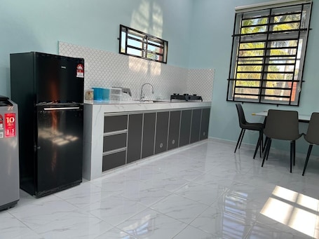 Fridge, stovetop, cookware/dishes/utensils. Homestay Adilah D