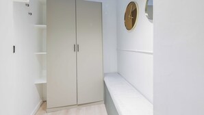 A room with a wardrobe, a bench, and a wall clock. - Charming Duplex - 2br/6p - Saint Germain (Paris)