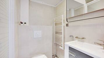 Appartement | Badkamer | Een haardroger, handdoeken, shampoo