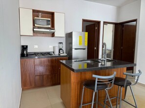 Fridge, microwave, stovetop, coffee/tea maker