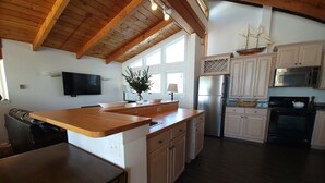 A kitchen with wooden cabinets, a built-in oven, and a microwave.