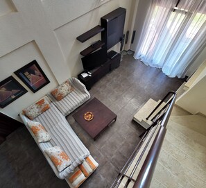 A modern living room with a sofa, a coffee table, and a flat-screen TV. - Evlogia Village by Greek Pride (Nea Skioni)