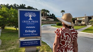 A sign for Greek Pride Hotels, indicating a Luxury Village.