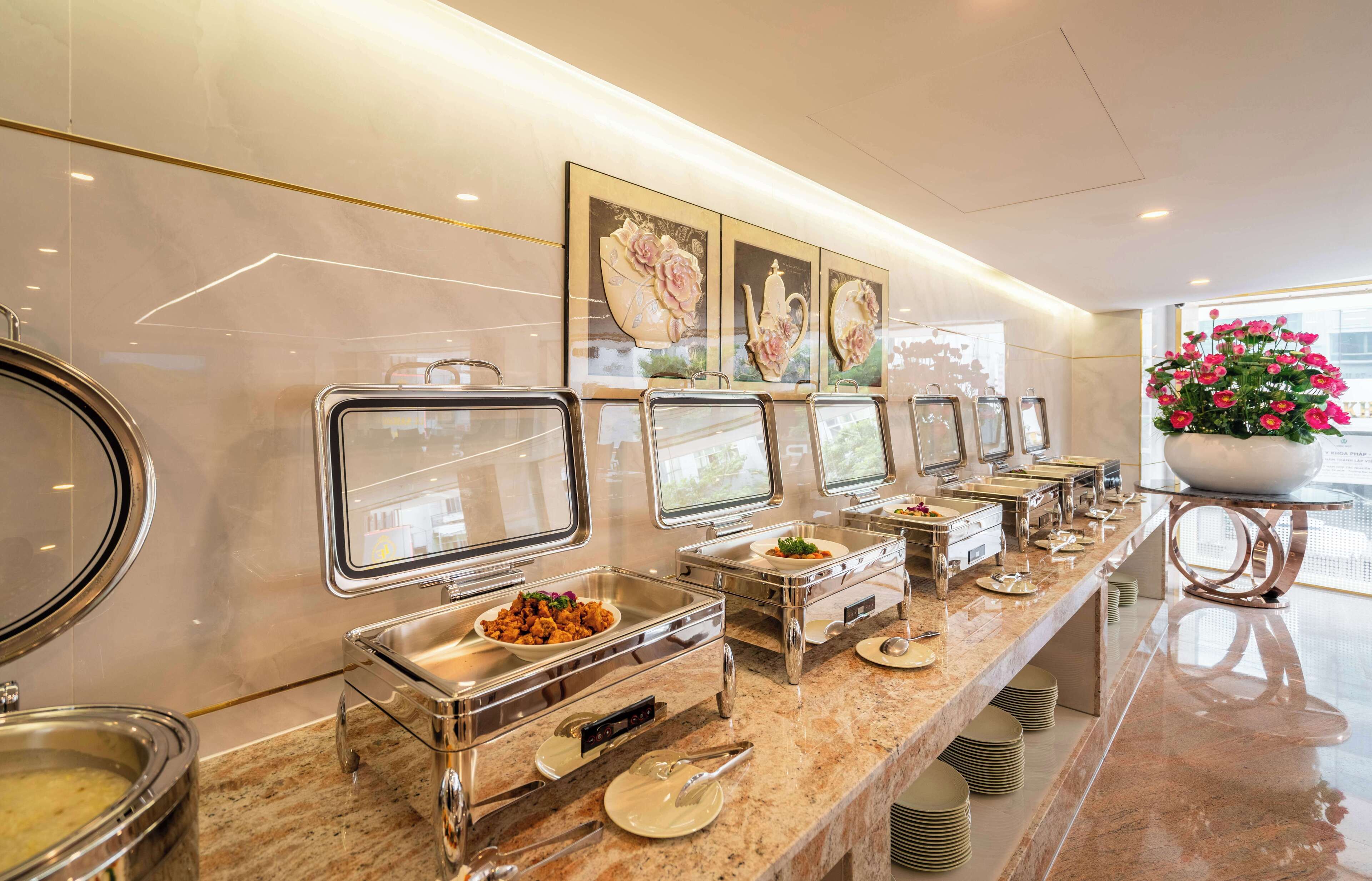 A buffet setup with multiple serving stations, each with a glass container and a metal tray.