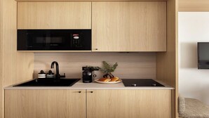 A compact kitchen with a Bosch microwave, a sink, a coffee maker, and a small plant on the counter. - Luxurious studio -Panthéon/Jardin de Luxembourg (Paris)
