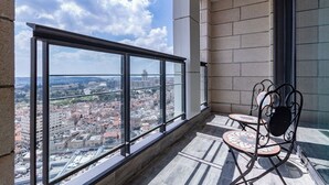 A balcony with a city view, a small table, and a chair. - JTower  Magical 4BR Parking with amazing view, city center (Jerusalem)