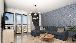 A modern living room with a grey sofa, a wooden coffee table, and a patterned wall. - JTower  Magical 4BR Parking with amazing view, city center (Jerusalem)