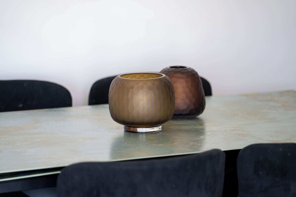 A table with two ceramic vases on it.
