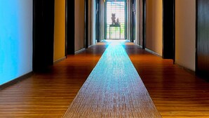 A long, narrow hallway with wooden flooring and a central light strip. - Limited to one pair per day! The entire building is reserved for private use! A luxurious inn designed in a modern Japanese style! You can enjoy your private time in the nature of Amami Oshima with a large projector. ⭐︎ (龍郷町)
