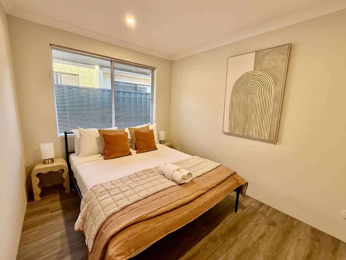 Step into a serene retreat designed for ultimate relaxation. This private bedroom offers a peaceful escape with a plush bed, fresh linens, and soft lighting. Unwind by the window, surrounded by thoughtful touches that make you feel right at home.