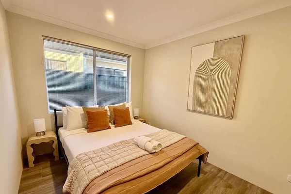 Step into a serene retreat designed for ultimate relaxation. This private bedroom offers a peaceful escape with a plush bed, fresh linens, and soft lighting. Unwind by the window, surrounded by thoughtful touches that make you feel right at home.