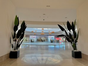 A spacious lobby with a high ceiling, large windows, and modern pendant lighting. - Rosetta Hotel & SPA (Sharm El Sheikh)