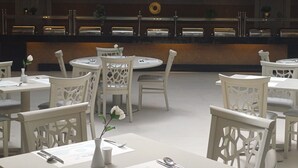 A spacious, multi-level dining area with white furniture and a central serving counter. - Rosetta Hotel & SPA (Sharm El Sheikh)