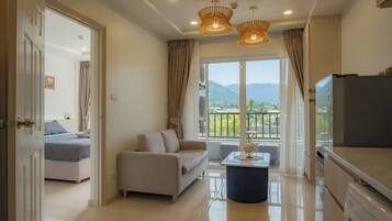 Deluxe Condo, 1 King Bed | Living area | 45-inch Smart TV with digital channels