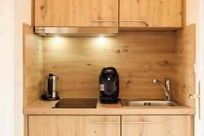 Fridge, stovetop, coffee/tea maker, cookware/dishes/utensils