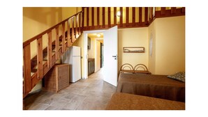 A staircase leading to a bedroom with a bed, a nightstand, and a small table. - 2 bedroom nice apartment in Briatico (Briatico)