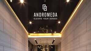A modern hallway with a tiled floor, decorative lighting, and a view into a room with a large window. - Sea View Room Luxury Amenities (Muang Pattaya)
