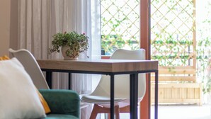 A dining area with a table, chairs, and a potted plant. - HOUSE OF SONJA (Viterbo)