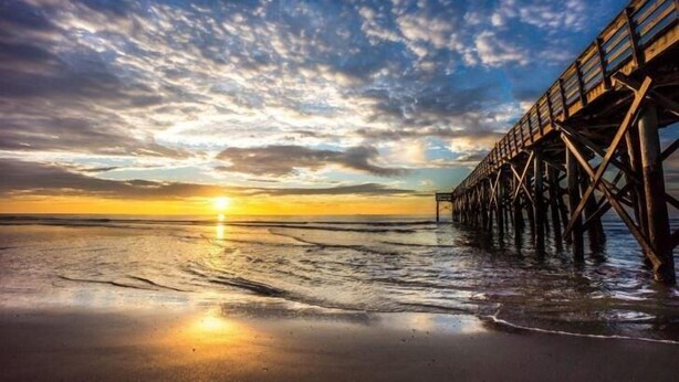 A pier extending into the water with a sunset in the background. - Shem Shack-Old Village, 5 mins to Beach (Mount Pleasant)