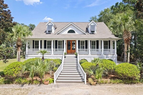 A two-story house with a front porch, a central door, and a staircase leading to the entrance. - Boview Hall- Pool, Hot Tub-15 mins to Kiawah (Johns Island)