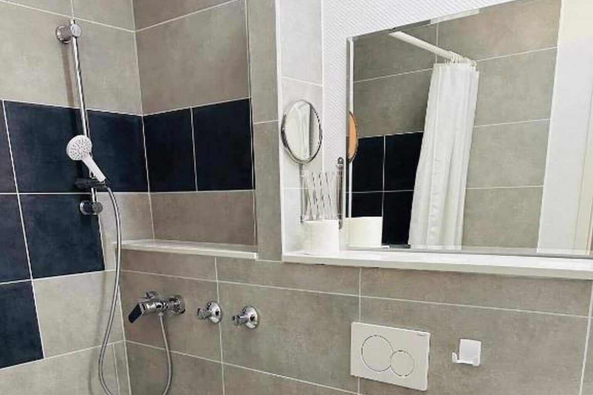 A bathroom with a bathtub, toilet, and sink.
