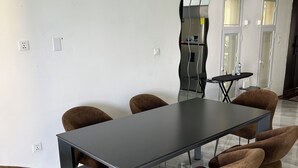 A modern dining area with a rectangular table and six brown upholstered chairs. - Beach Front 2 Bed Condon C1.1 with Sea View and Private Pool !! (Simpson Bay)