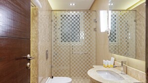 A modern bathroom with a glass shower enclosure, a toilet, a sink with a vanity, and a mirror. - VESTA - New Cairo Residennce (New Cairo)