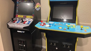 Two arcade machines, one labeled 'Champion Street Fighter II Edition' and the other 'The Simpsons'. - Walk to Downtown CDA | Sleeps 8 | Arcade + Pets (Coeur d'Alene)