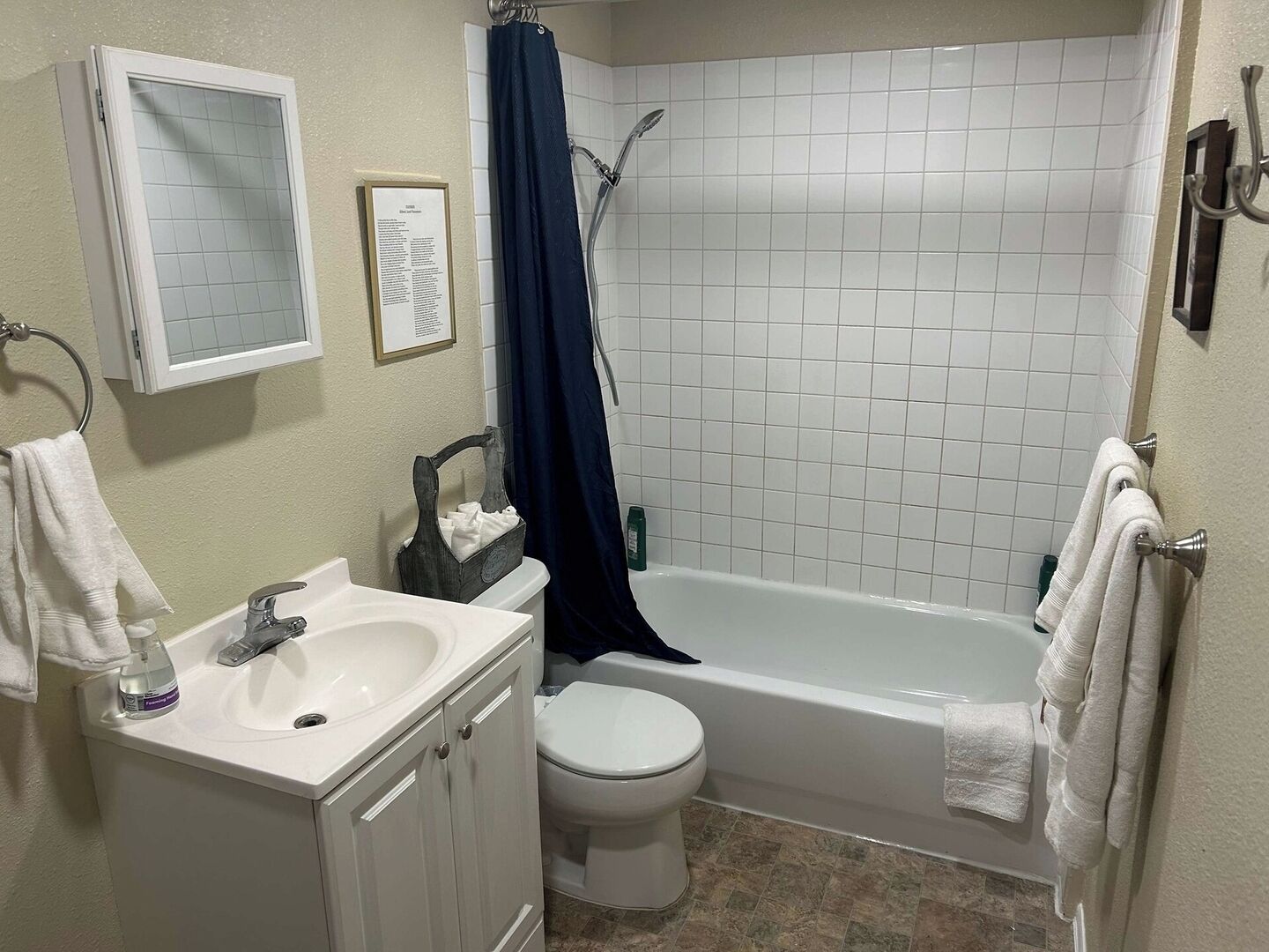 A bathroom with a white sink, toilet, and bathtub.