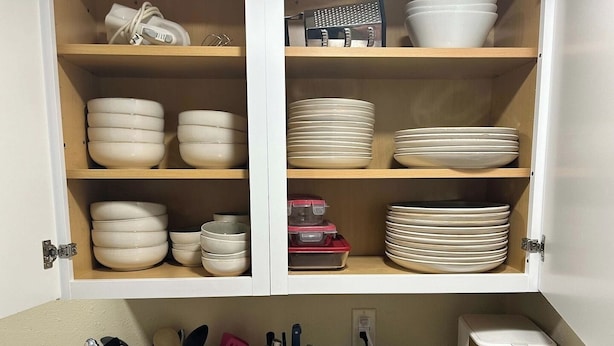 A kitchen with white cabinets, a wooden spice rack, a toaster, and a coffee maker. - Walk to Downtown CDA | Sleeps 8 | Arcade + Pets (Coeur d'Alene)