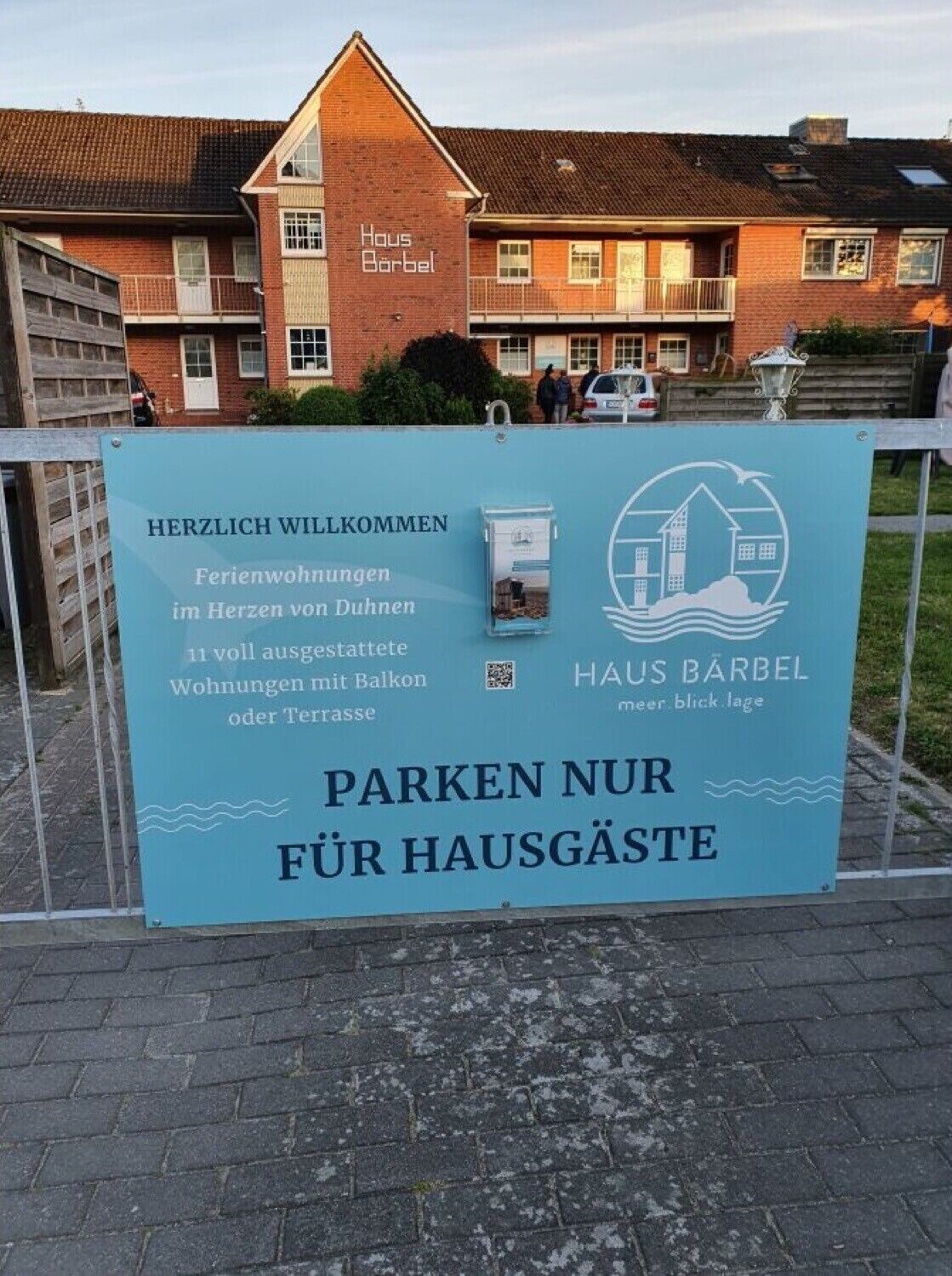 A sign for Haus Barbel with a message welcoming visitors and indicating parking is only for residents.