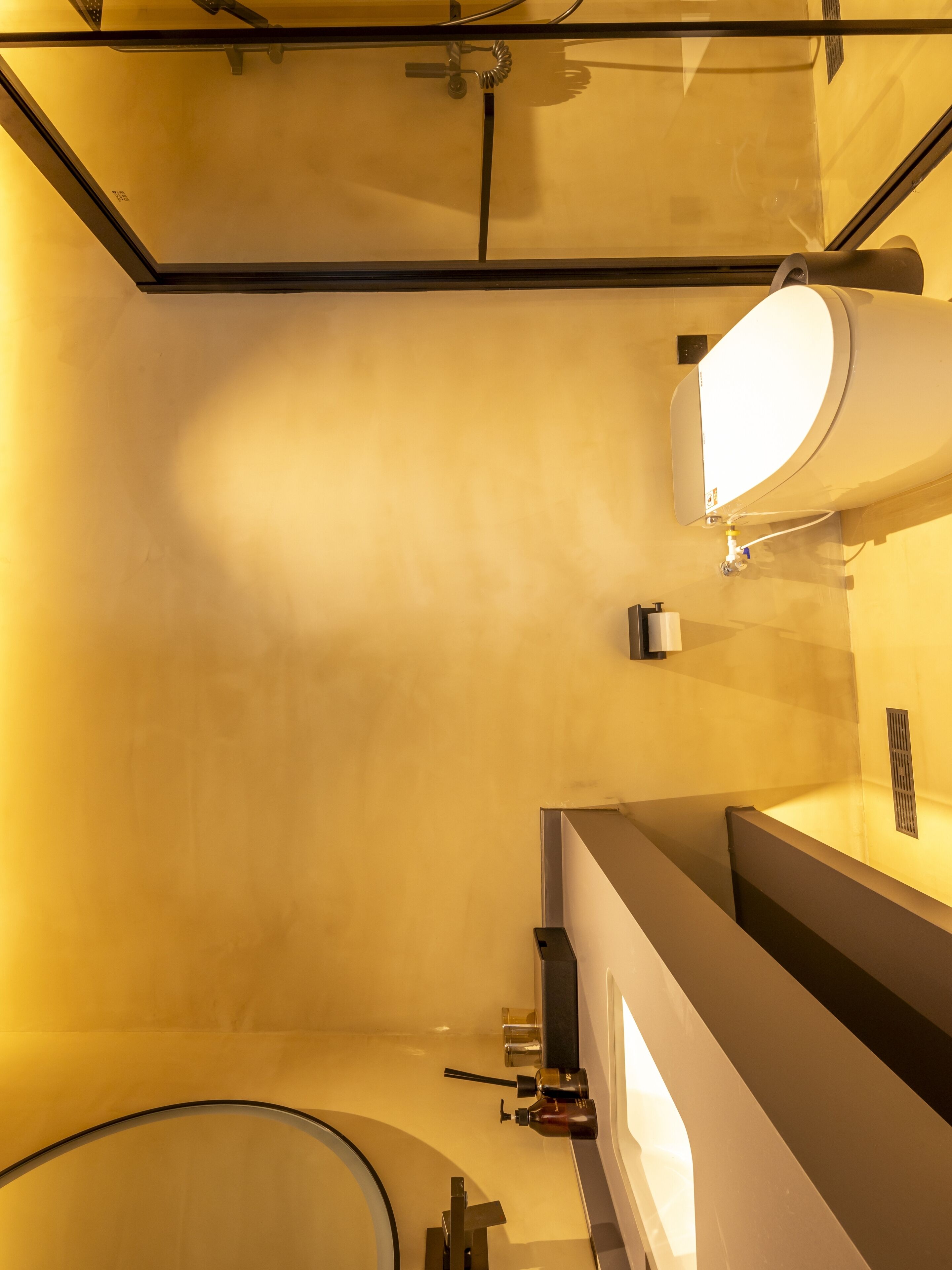 A modern bathroom with a glass enclosure, a large mirror, and a sink with a faucet.