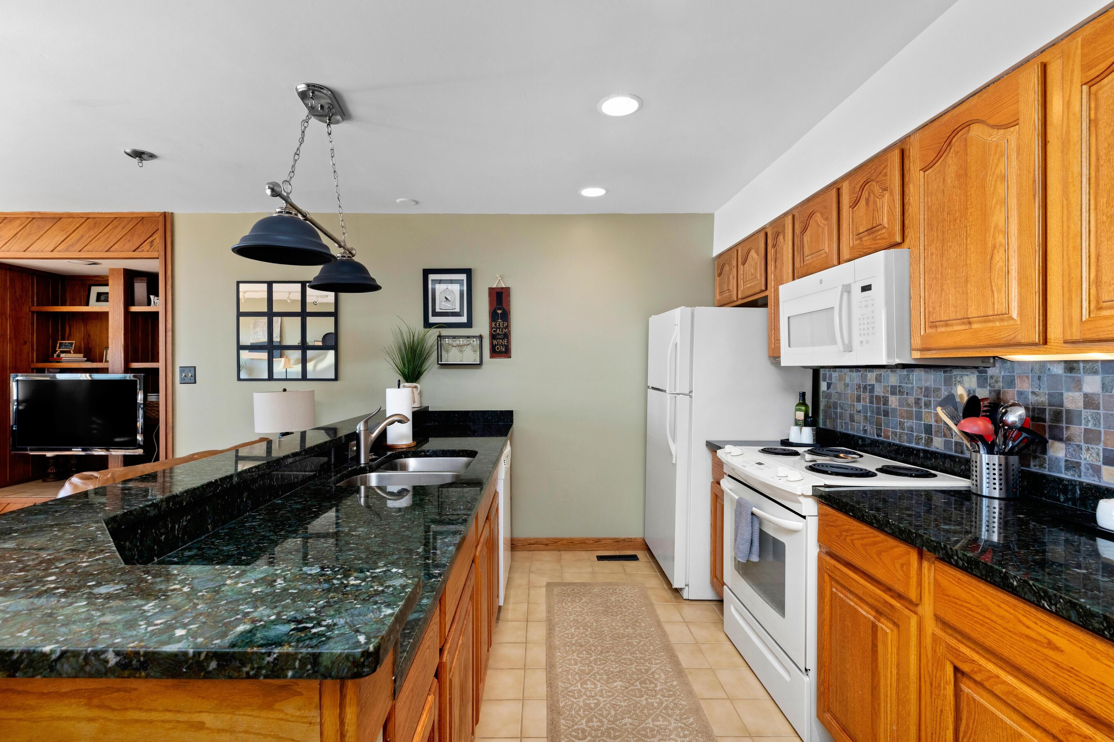 Fridge, microwave, coffee/tea maker, cookware/dishes/utensils