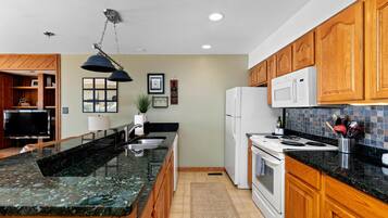 Fridge, microwave, coffee/tea maker, cookware/dishes/utensils