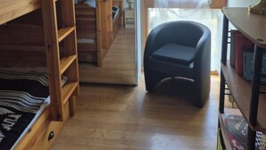 A room with bunk beds, a desk, a chair, and a window with a view of trees. - Your stay in the Alps between lakes and mountains. (Saint-Théoffrey)