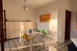 A dining area with a table, chairs, and a ceiling fan. - Villa with garden just minutes from the sea (Sparvasile)