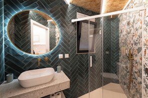 Comfort studio | Badkamer | Een douche, een haardroger, handdoeken, zeep