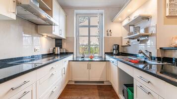 Fridge, dishwasher, coffee/tea maker, cookware/dishes/utensils